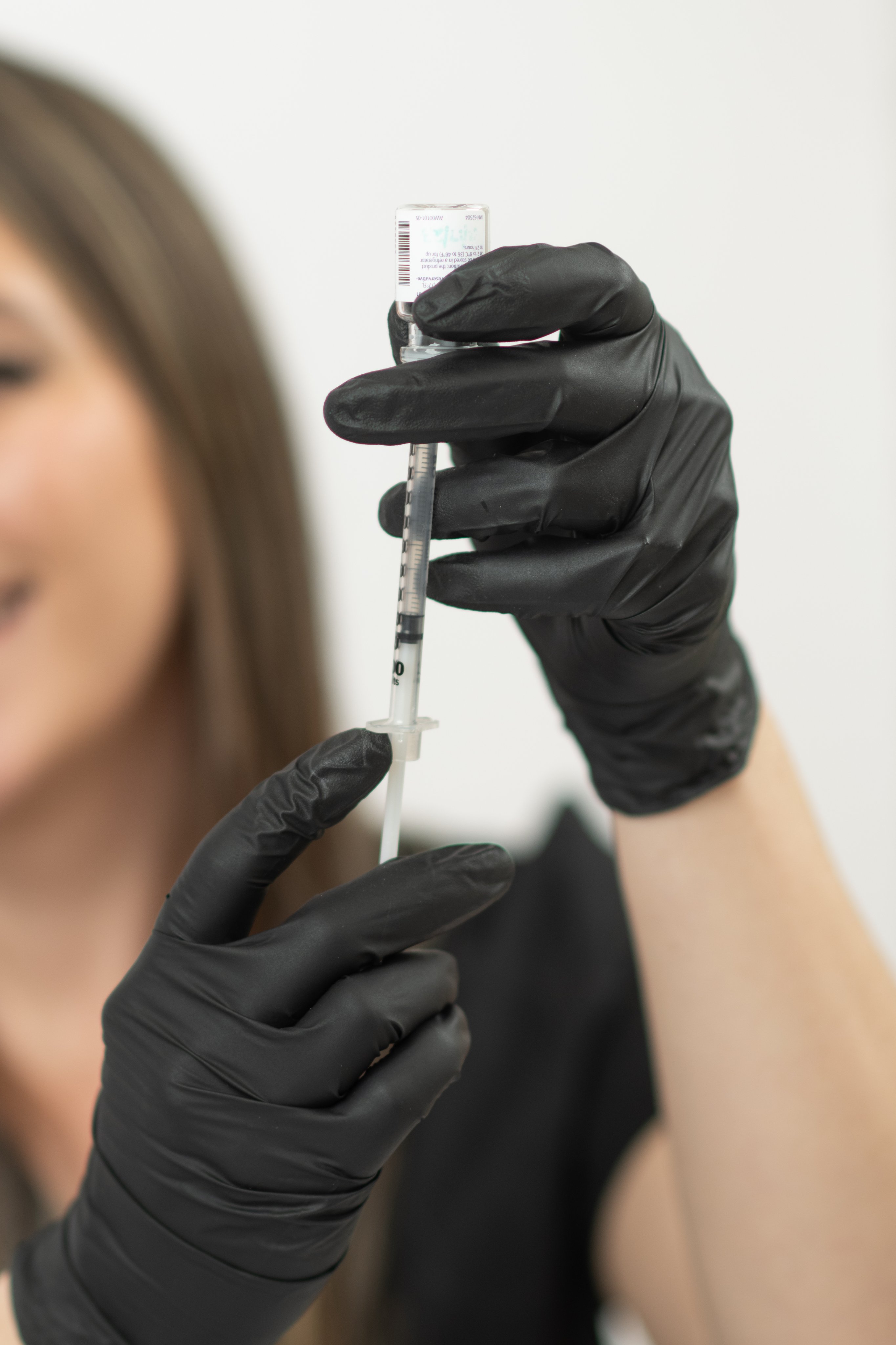 Sarah Jones, FNP-BC preparing a treatment at Glow Medical Group