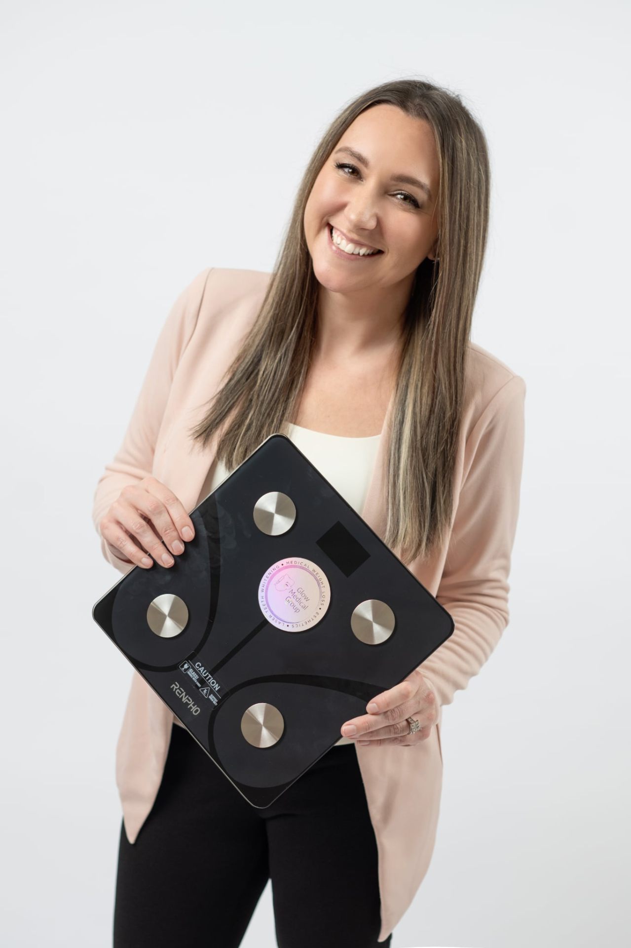 Sarah holding Glow branded scale